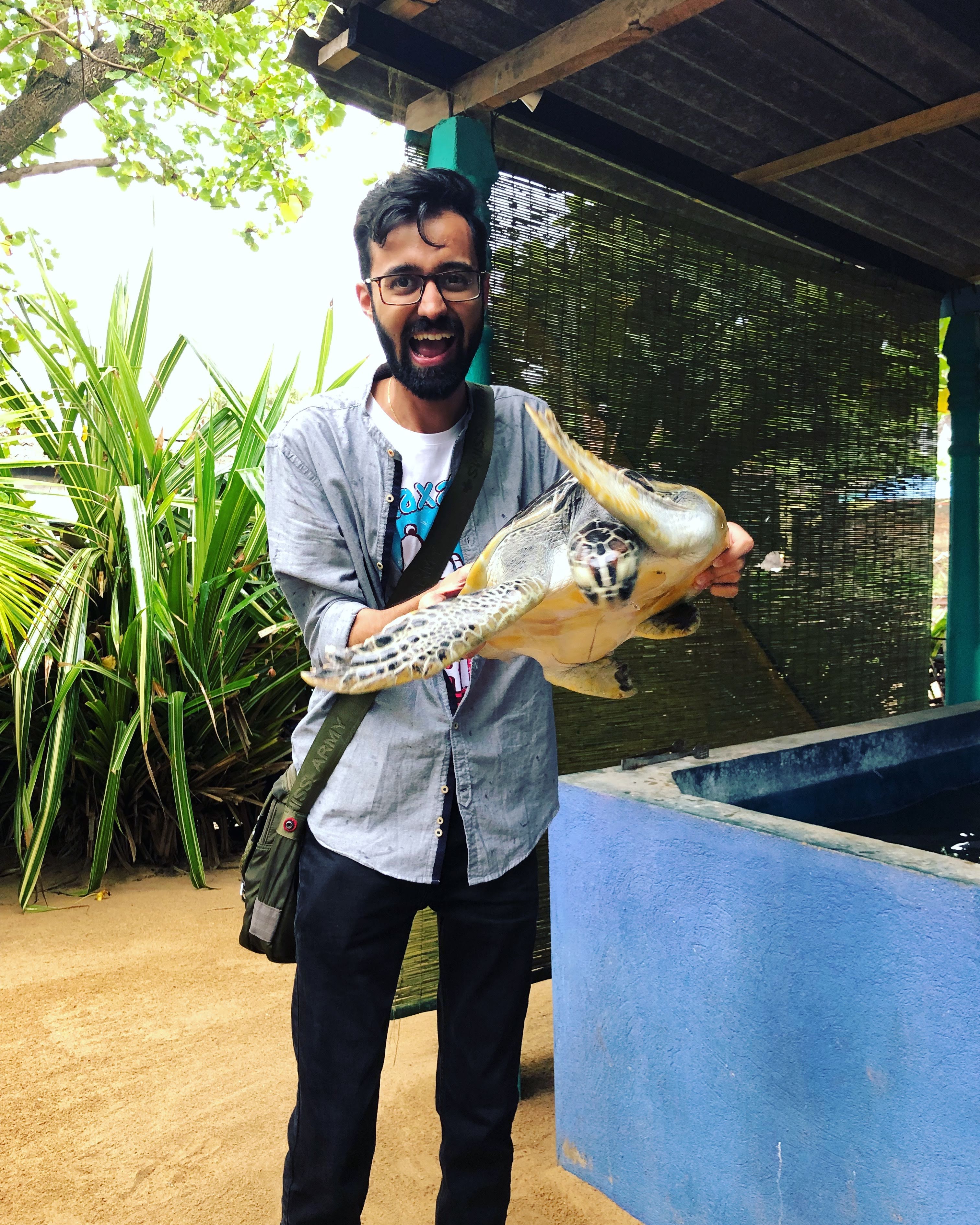 Sanket Pathak holding a sea turtle